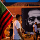 A man carries a Black Liberation flag through a Juneteenth celebration at the memorial for George Floyd outside Cup Foods on June 19, 2020, in Minneapolis, Minnesota.